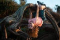 Child climbing tree. Cute kid climbing the tree in the park, happy childhood concept. Royalty Free Stock Photo