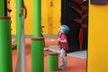 Child climbing on wall in amusement centre. Climbing training for children. Little girl in dressed climbing gear climb high. Royalty Free Stock Photo