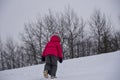 The child climbs hard up the snowy hill