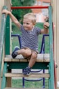 The child climbs the stairs in the playground Royalty Free Stock Photo