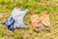 Child clothes laying on grass ground under bright sun Royalty Free Stock Photo