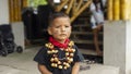 Child of the Cofan ethnic group wearing their traditional clothing adorned with a necklace made with seeds in the Cofan Dureno