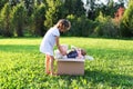 Child collecting toys for charity. Soft toys in cardboard donation box outdoors