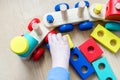 The child collects a toy wooden train. Royalty Free Stock Photo