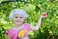 The child collects apples