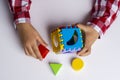 The child collects the cube sorter constructor. Puzzle cube sorter, an early development concept Royalty Free Stock Photo