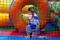 A child on a colorful trampoline. A happy little girl is having fun on an inflatable playground. The baby is playing in an inflata Royalty Free Stock Photo