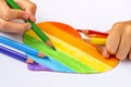 A child coloring multicolored heart Royalty Free Stock Photo