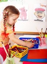 Child with colour pencil in play room. Royalty Free Stock Photo