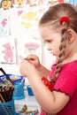 Child with colour pencil in play room. Royalty Free Stock Photo