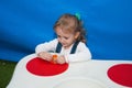 The child concentrates at the game table in the designer