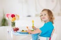 Child cooking, eating. Kids cook in kitchen Royalty Free Stock Photo
