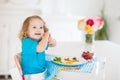 Child cooking, eating. Kids cook in kitchen Royalty Free Stock Photo