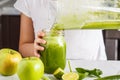 Child cooking spinach apple cucumber smoothie. Healthy plant based food concept Royalty Free Stock Photo