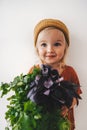 Child with coriander and basil bunch vegan food healthy eating organic harvest gardening plant based diet Royalty Free Stock Photo