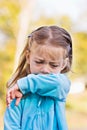 Child coughing or sneezing into arm Royalty Free Stock Photo