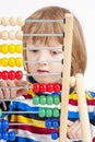 Child Counting on Colorful Wooden Abacus