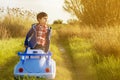 Child in the countryside stand up in his toy car