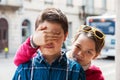 Child covers his eyes of his brother