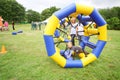 Child crawls in large inflatable wheels