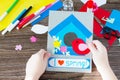 The child create a spring greeting card paper bird and birdhouse. Made by hand. Craft for kids. Royalty Free Stock Photo