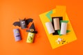 Child creates decorations for Halloween party from toilet roll. Easy eco-friendly DIY master class, craft for kids. Materials for