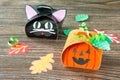 The child creates a gift box of a black cat of Halloween and a pumpkin of Halloween.