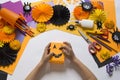 The child creates a hand-crafted pumpkin. Children`s hands.