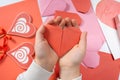 The child creates a hearts out of paper, hands close-up. Origami for Valentine& x27;s Day. Royalty Free Stock Photo