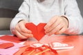 The child creates a hearts out of paper, hands close-up. Origami for Valentine& x27;s Day. Royalty Free Stock Photo