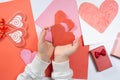 The child creates a hearts out of paper, hands close-up. Origami for Valentine& x27;s Day. Royalty Free Stock Photo