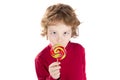 Child crossed eyes licking lollipop candy