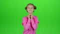 Child crosses his fingers, she hopes to win. Green screen. Slow motion