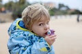 Child, cute boy, playing with ceramic clay whistle in the form of bird, souvenir from park Guell in Barcelona Royalty Free Stock Photo