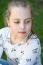 Child with cute face outdoor. Little girl with young skin on spring or summer day. Beauty kid with fresh look and long blond hair. Royalty Free Stock Photo