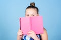 Child cute girl hold notepad or diary blue background. Childhood memories. Diary for girls concept. Note secrets down in