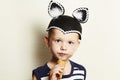 Child. cute kid boy eating ice cream in studio.masquerade