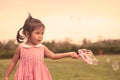 Child cute little girl having fun to play with her bubbles toy Royalty Free Stock Photo