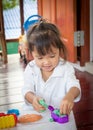 Child cute little girl playing with clay Royalty Free Stock Photo