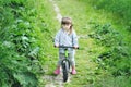 Child cute little girl riding bike in forest Royalty Free Stock Photo