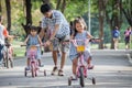 Child cute little girl riding bike in park