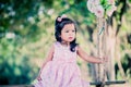 Child cute little girl sitting on swing in the park Royalty Free Stock Photo