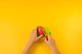 A child cuts a plastic fruit on a board