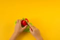 A child cuts a plastic fruit on a board