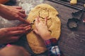 Child cutting gingerbread of metal molds