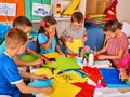 Child cutting paper in class. Development social lerning in school.