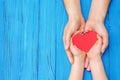 Child and dad hands holding red heart Royalty Free Stock Photo