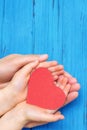 Child and dad hands holding red heart Royalty Free Stock Photo