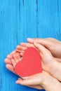 Child and dad hands holding red heart Royalty Free Stock Photo