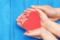 Child and dad hands holding red heart Royalty Free Stock Photo